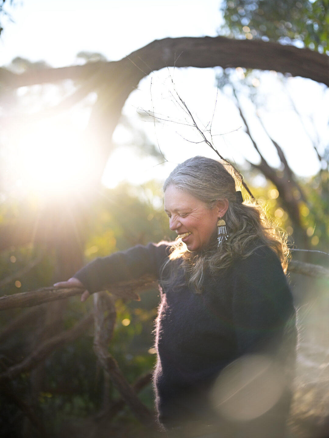 A beautiful capture of a mature woman's smile as the sun sets behind her. This portrait was captured at Woods Bushland Reserve in Tuerong on the Mornington Peninsula