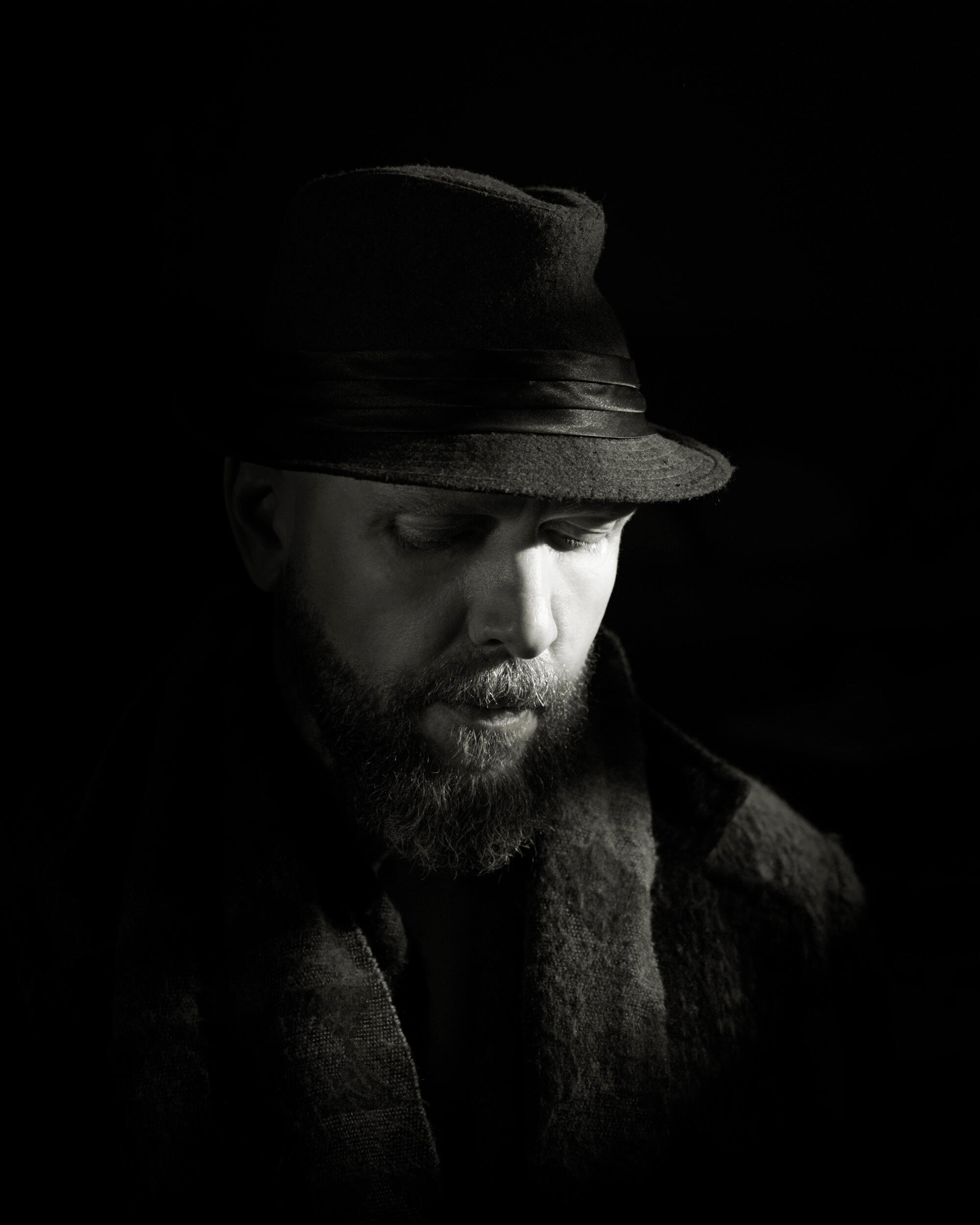 Nostalgic Man A man in deep consideration with soft expression. I love the lighting in this. It lends well to the black and white sepia cinematic tone. It evokes such sweet emotion
