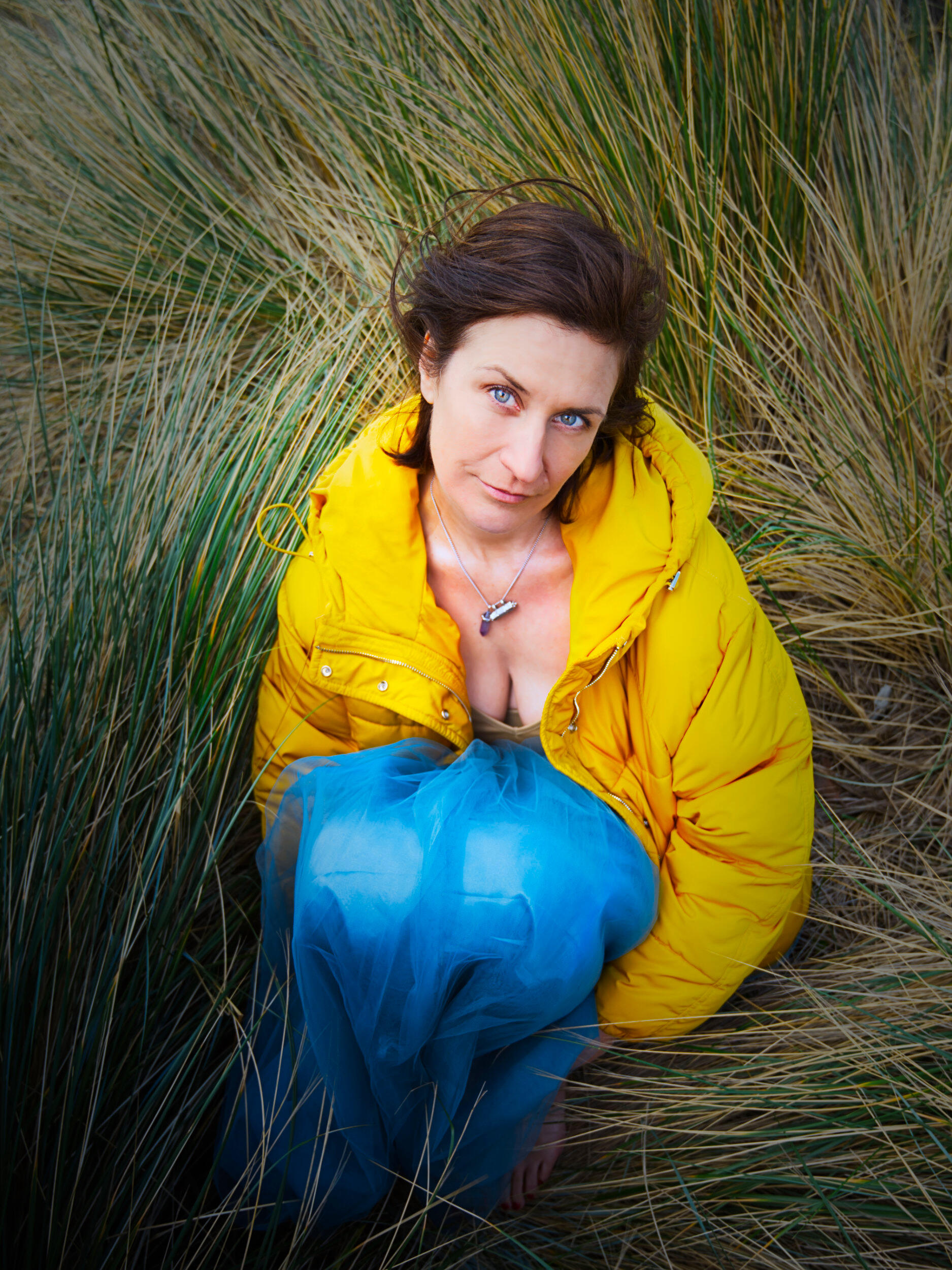 Vibrant colours amongst the beach grasses This portrait leans more to my fashion attributes. I love the outfit and the colour palette, and her content expression. Captured at Seaford Beach, Victoria.