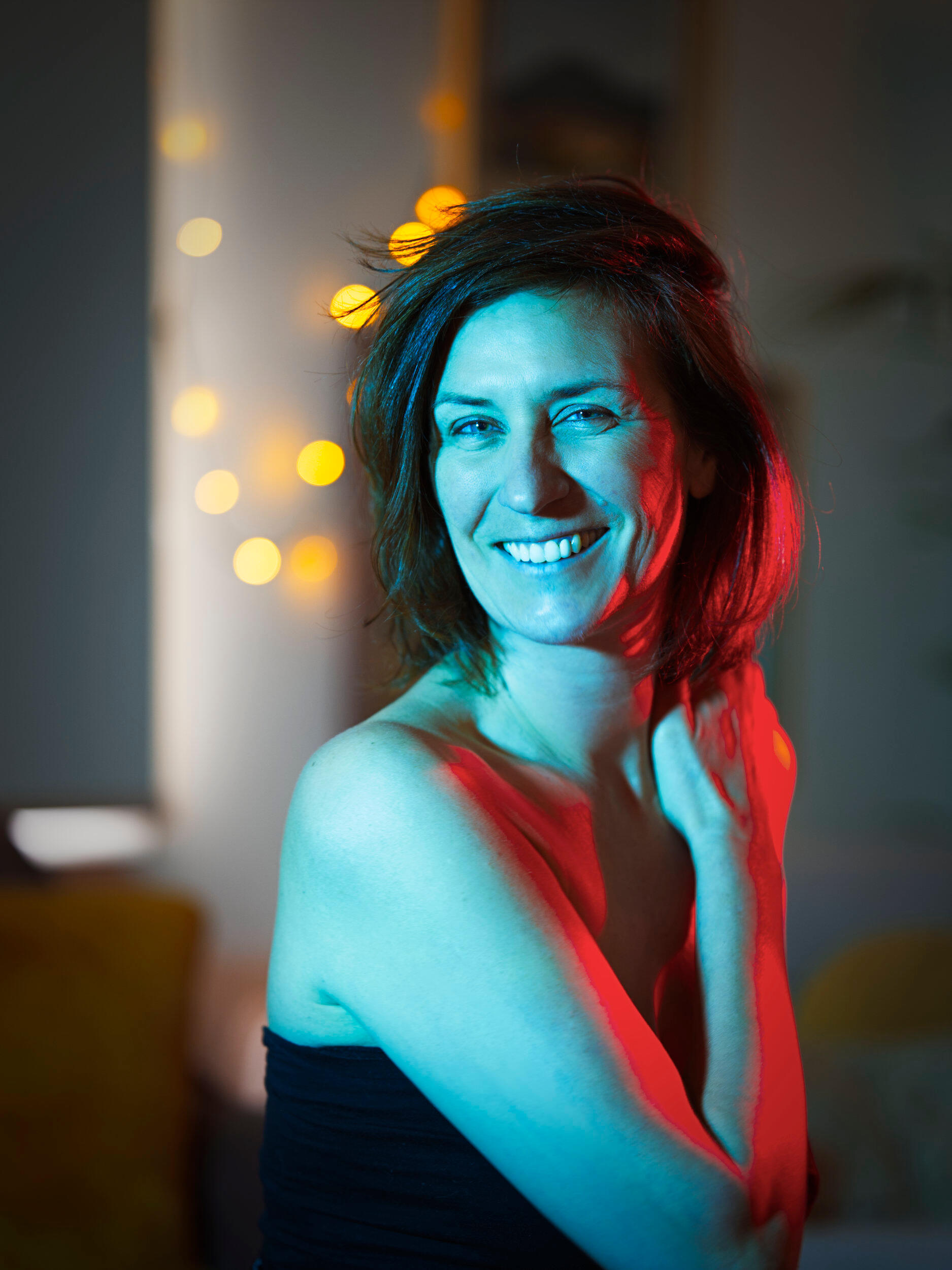 I shot this portrait while we sipped coffee at a cafe in Frankston, Victoria. I loved the red and blue lighting contrasting skin tones against the background fairy lights