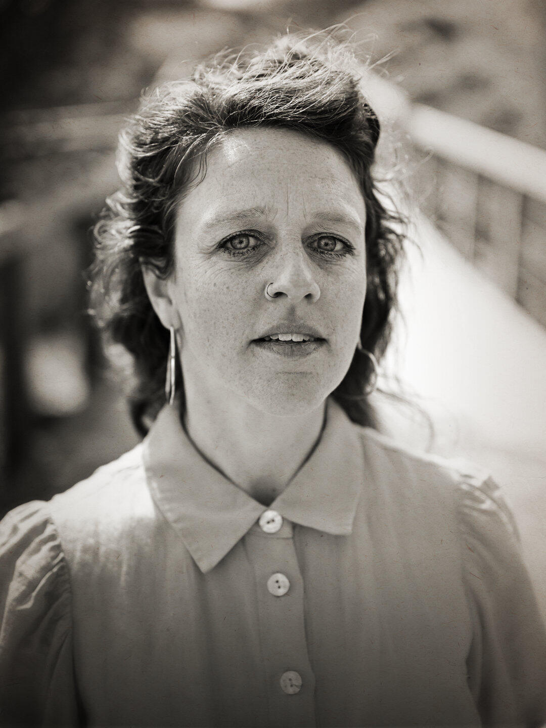 A black and white sepia portrait of a woman with more in her eyes than can be seen. Stylistically I adopted a folklore kind of energy in the edit